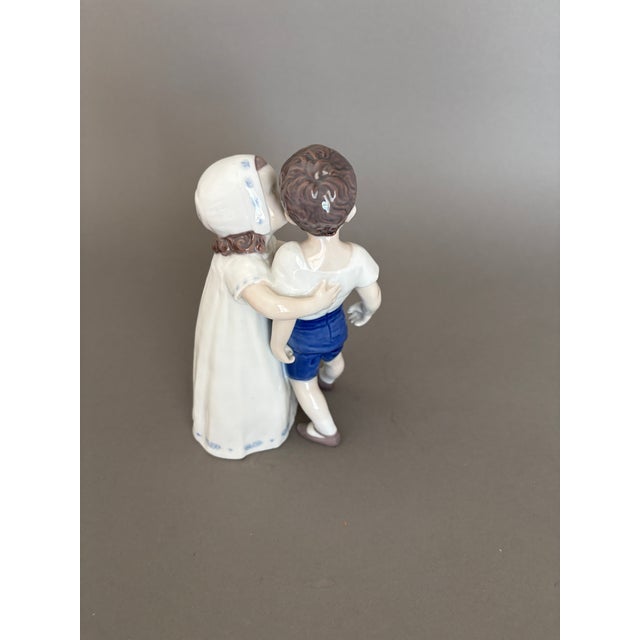 Adorable girl trying to kiss little boy but he refuses! This figurine was given me by my mother when I had a new daughter...