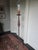 Stunning 1970's sculptural floor lamp crafted from iron. Features a slender candlestick stem over a tripod base. The lamp...