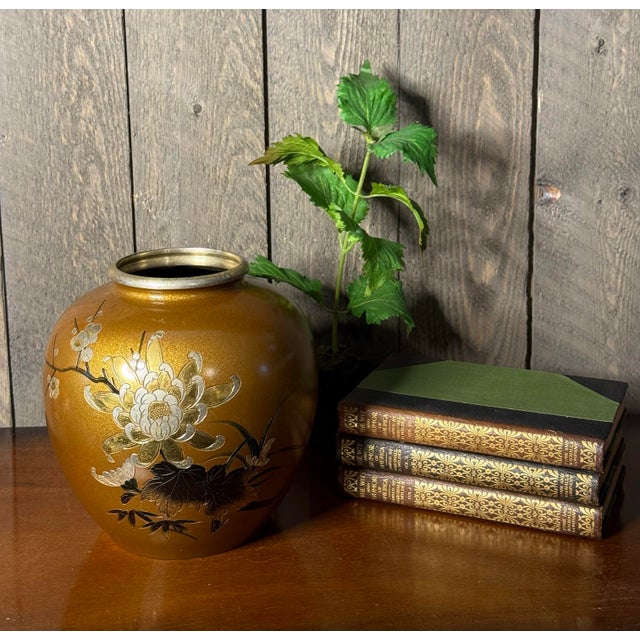 A luminous gold-ground vase with delicate floral relief—an effortless statement in any curated vignette. A richly toned...