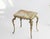 Small rectangular onyx table with an ornate brass base. The table is made in Italy and typical from the Hollywood Regency...