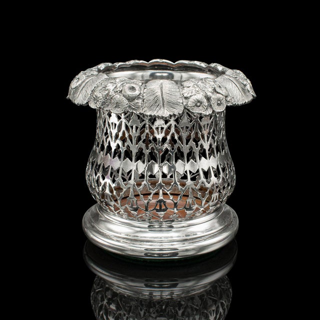 This is an antique bottle coaster. An English, silver plated decorative drinks rest, dating to the Victorian period, circa...
