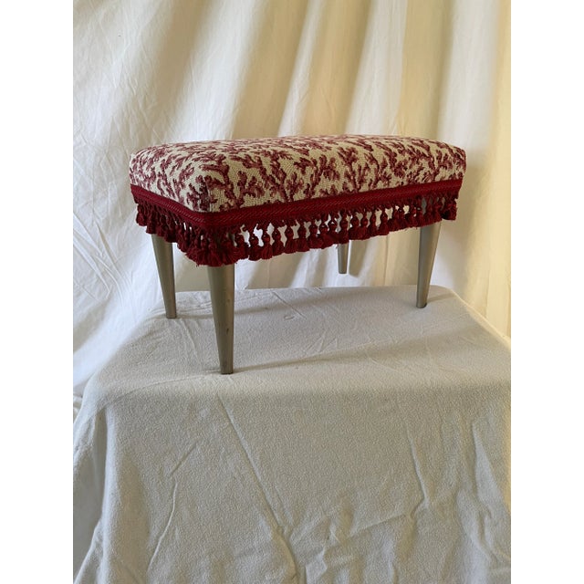 Small footstool reupholstered in beautiful burgundy upholstery weight Scalamandre fabric with tassel trim