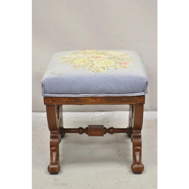 Antique Eastlake Victorian Burl Walnut Carved Curule Footstool Ottoman Stool with Blue Needlepoint Floral Upholstery....