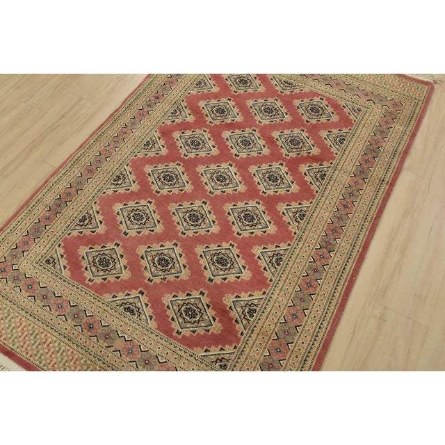 A tribal Bokhara Jaldar rug hand-knotted with an all-wool pile on a cotton foundation. This finely woven oriental rug...