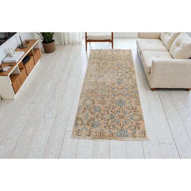 This is a vintage Turkish Oushak rug from the Mid 20th Century. The piece was hand-knotted.