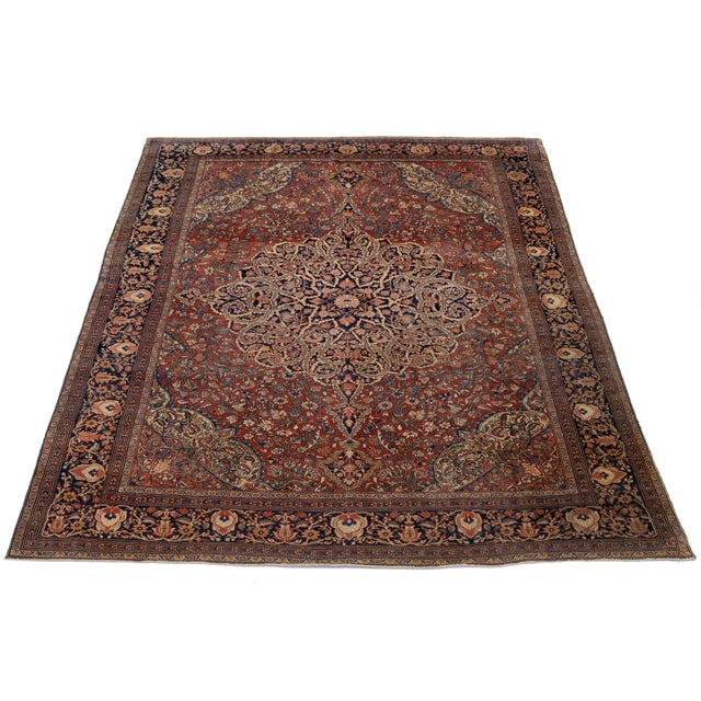 This is a beautiful antique Persian Farahan hand-knotted wool rug from the 1880s. Its red-rust field features classic...