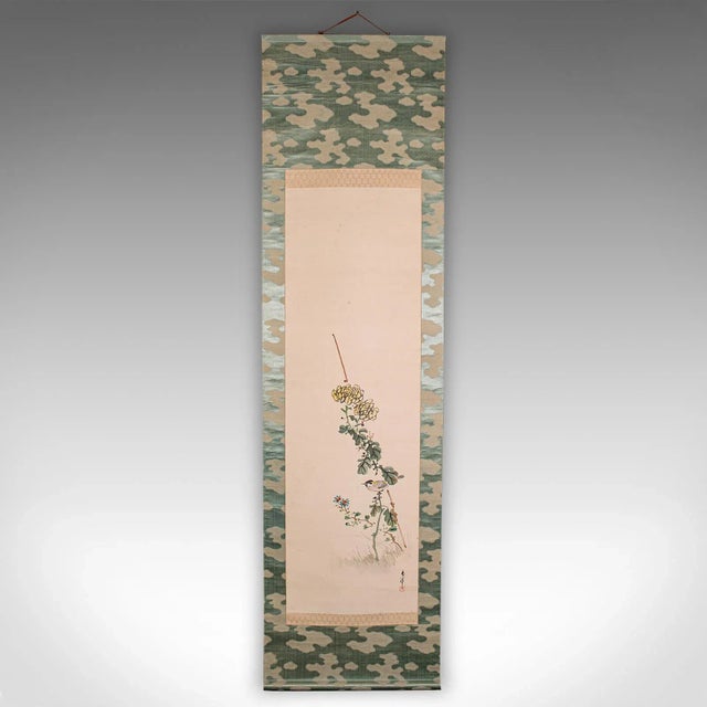 This is a tall antique scroll painting. A Japanese, silk cotton rolling wall panel, dating to the early 20th century,...