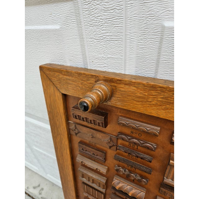Antique mercantile double-sided display of various wood trim, molding or wooden appliques. This panel is sure to catch the...
