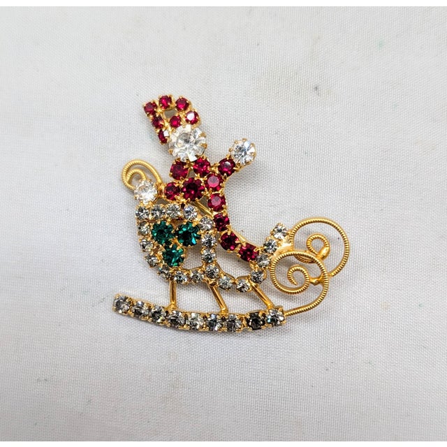 1960s goldtone prong set round clear, faux-garnet and faux-emeralds Santa Claus in his sleigh with filigree runners and...