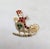 1960s goldtone prong set round clear, faux-garnet and faux-emeralds Santa Claus in his sleigh with filigree runners and...