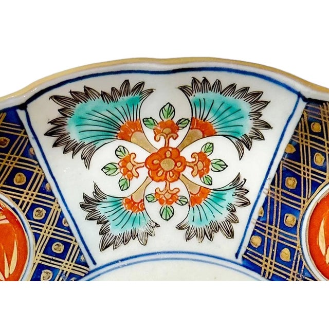 A late 19th century very colorful Japanese Imari plate with scalloped edges. Plate is signed.