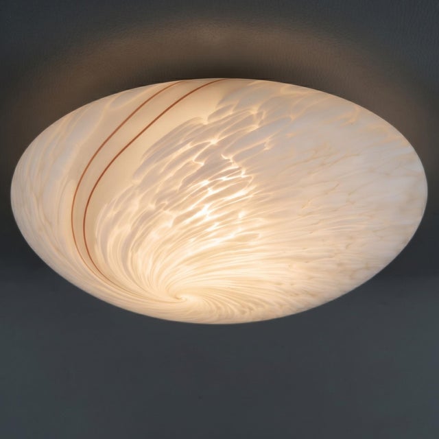 An elegant and rare designer ceiling light, ideal for enhancing living rooms, entryways, or professional offices with...