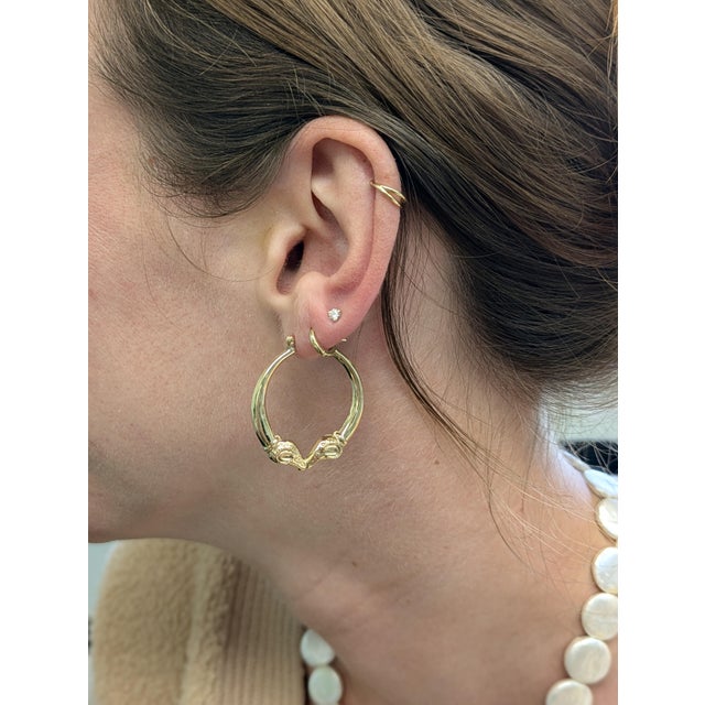 These eye-catching earrings feature a bold 31mm head size, crafted in 3.21g of 14k gold with an animal-inspired design...