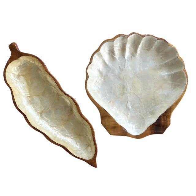 Add a splash of coastal elegance to your tabletop with this handcrafted set of two serving trays featuring a palm frond...