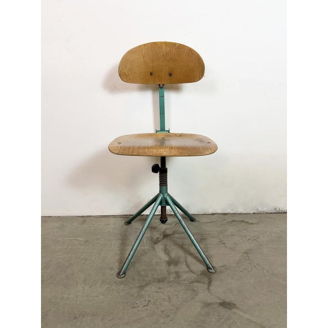 This industrial height adjustable, rotating chair was made in former Czechoslovakia during the 1950s.It features a dark...