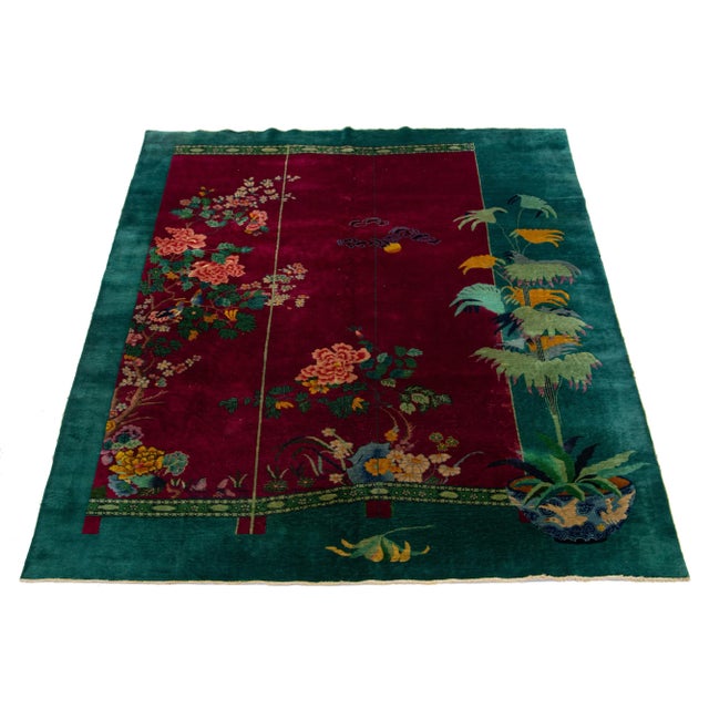 A beautiful vintage Chinese Art Deco hand-knotted Wool rug with a red field-wide, green frame and multicolor accents in...