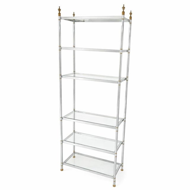 Vintage French Hollywood Regency étagère dating to the 1970s, featuring a polished chrome frame with brass finials, banded...
