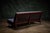 Armless sofa settee by George Nakashima with a slatted back and removable upholstered seat and back cushions. - Produced...