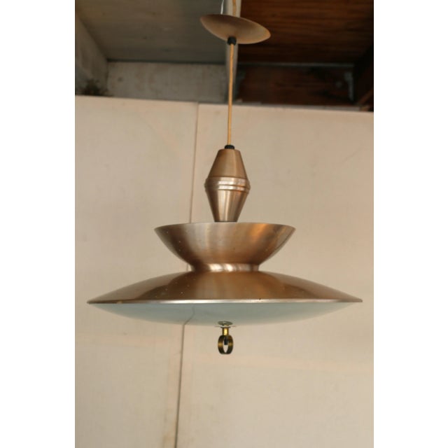 Mid-Century Modern (MCM) retractable pendant light fixture. This fixture is known for its "pull-down and retractable"...