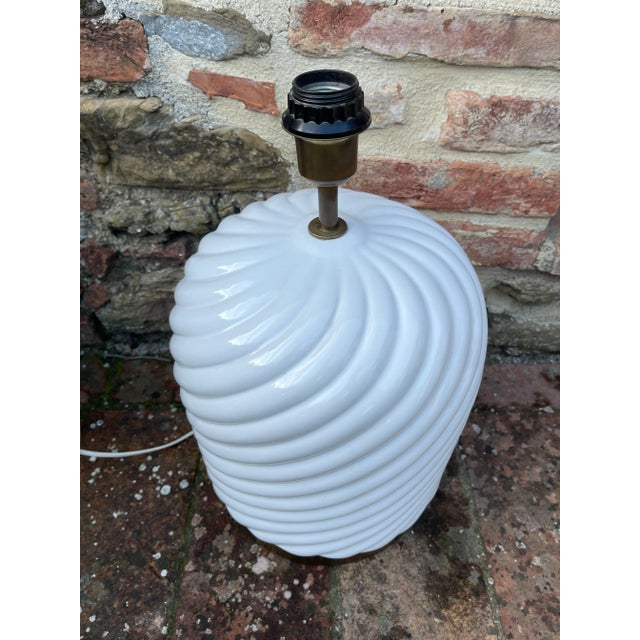 This is a gorgeous, clean white ceramic Tommaso Barbi lamp with a brass bottom base. It’s in fabulous condition. I chose...