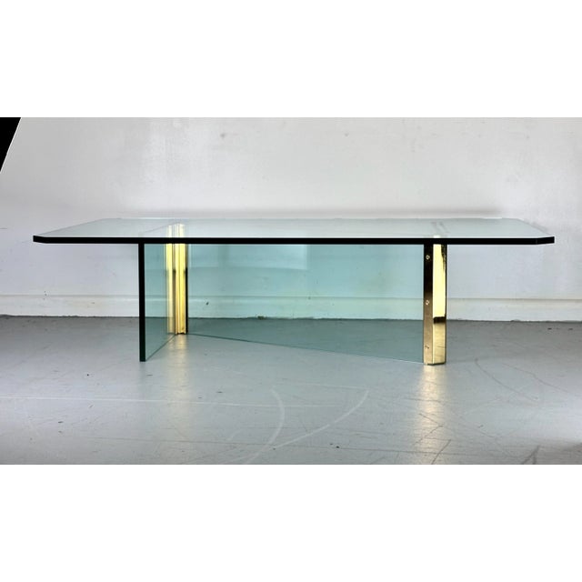 This striking Mid-Century Modern coffee table features a unique mix of brass and glass in a Z design with a thick beveled...