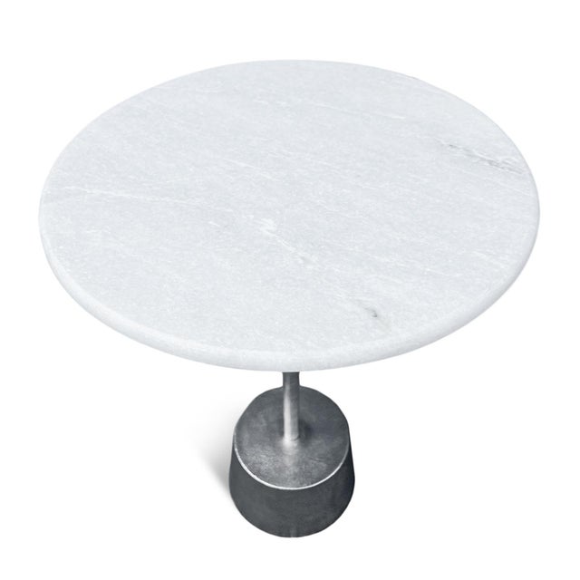 Deco modern round white marble top side table with nickel finish iron pedestal base. Each table may have variations in...