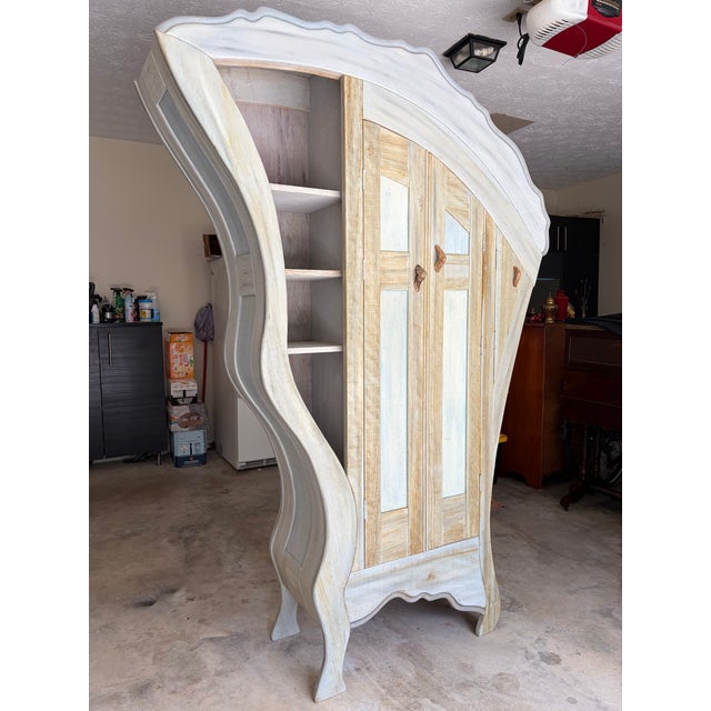 This handcrafted whimsical wardrobe was made by renowned furniture and ship builder Ted Box in his Martha's Vineyard...
