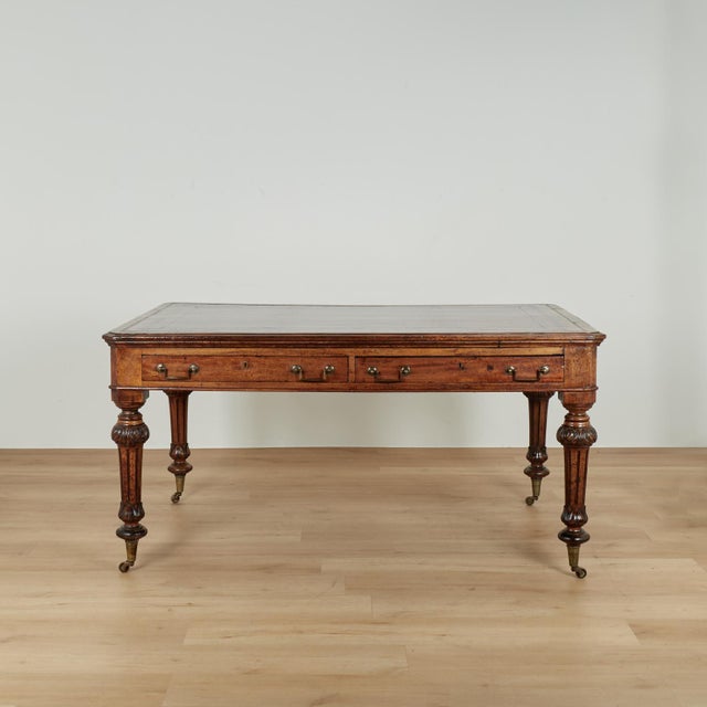 Handsome 19th century English desk or table handcrafted in mahogany featuring the original tooled leather top on a case...