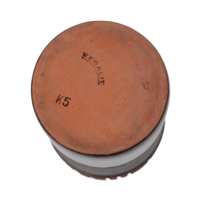 K5 type vase with an unconventional modernist design. The surface of the vase is shiny, glazed in shades of brown with a...