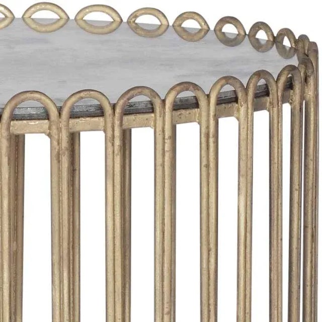 The Beatrice Side Table With gilded gold wire in an iron drum base and an antiqued mirror top, the Beatrice Side Table is...