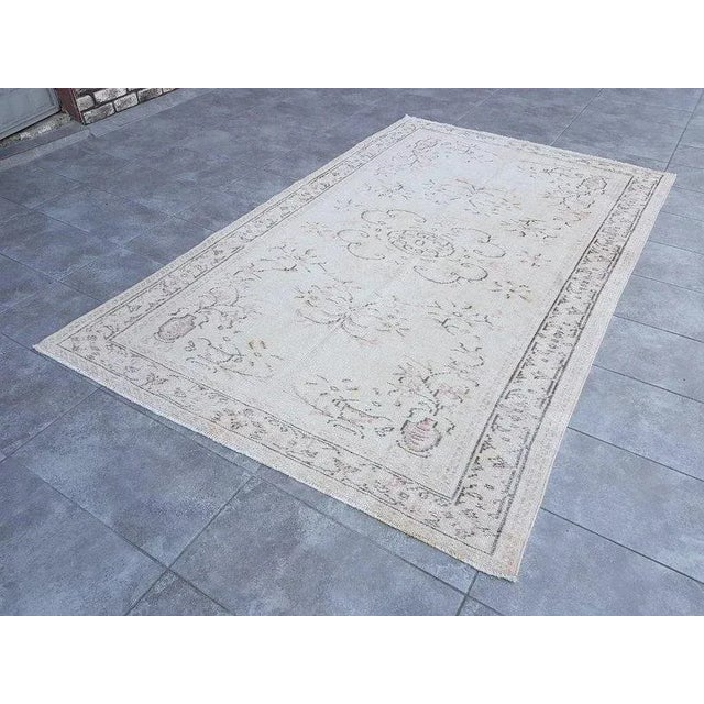 This is a vintage Turkish Oushak rug from the 1960s. The piece was hand-knotted