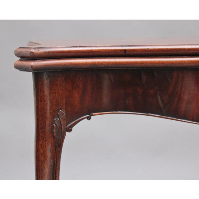19th Century mahogany card table, the moulded edge shaped top opening to reveal a green baize playing surface, the shaped...