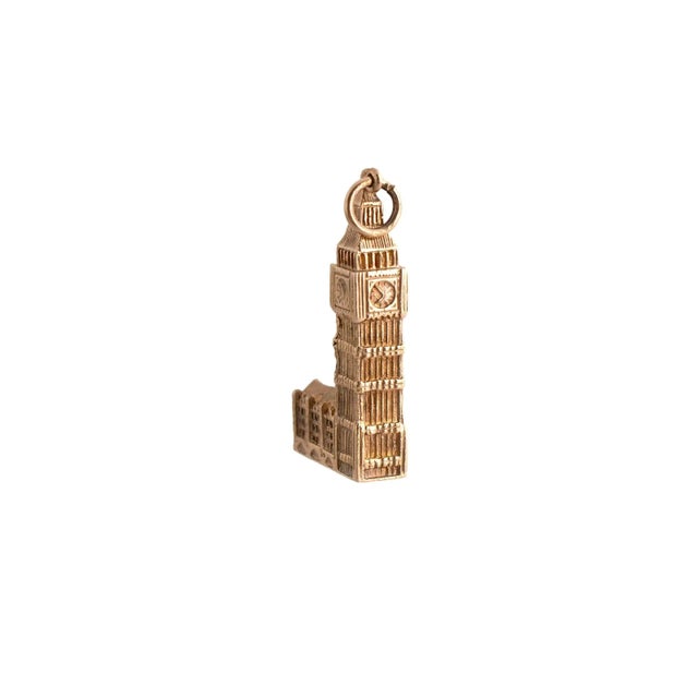 A 9k yellow gold charm depicting a detailed architectural structure. The piece measures 1.5 inches in length. This is a...