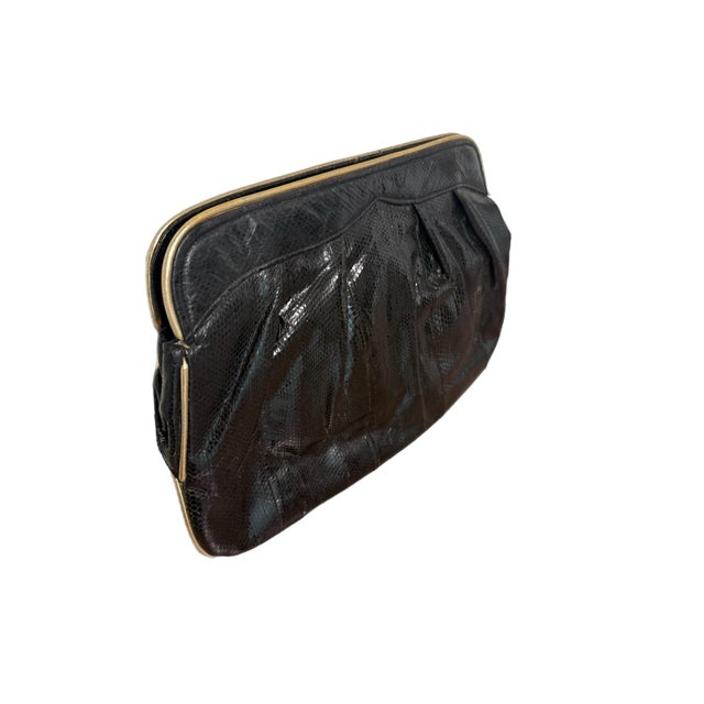 Barbara Bolan Too large black lizard clutch with pleated detail and gold trim. Attached gold leather shoulder strap. Circa...