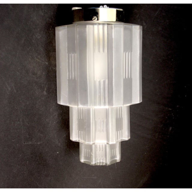 Etched glass body in the shape of a skyscraper with Art Deco ornament. Can be used as a table or ceiling lamp. The base is...