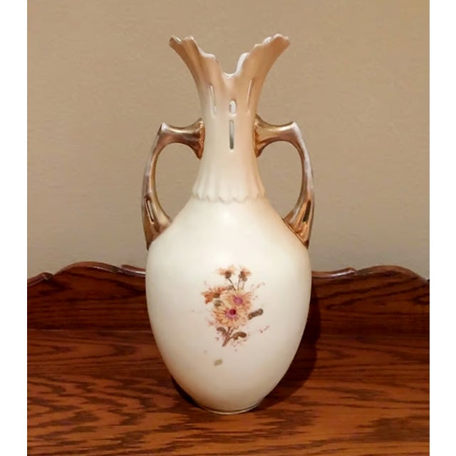 A stunning example of German artistry, this large antique porcelain vase features a sophisticated tall-shouldered...