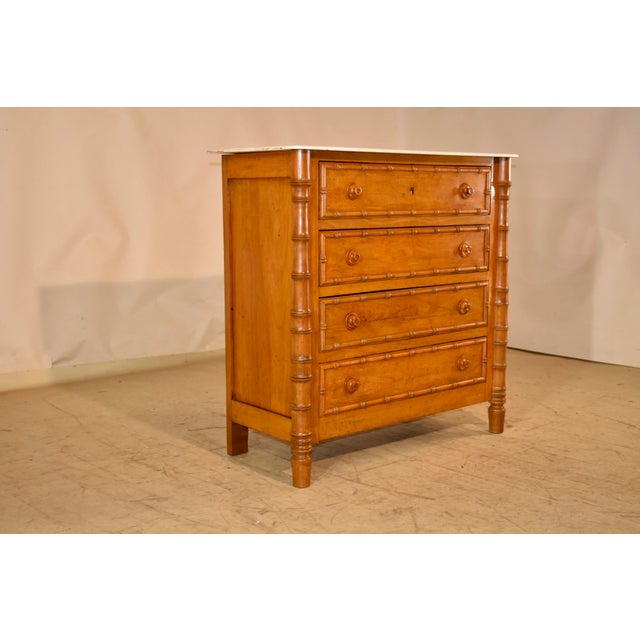 19th century faux bamboo chest with a marble top from France. The top is cut Carrera marble and appears to be original to...