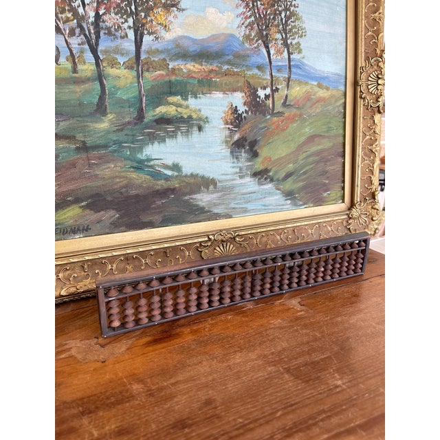 This likely antique Japanese abacus features a finely crafted wood frame with a rich, aged patina and a traditional five-...