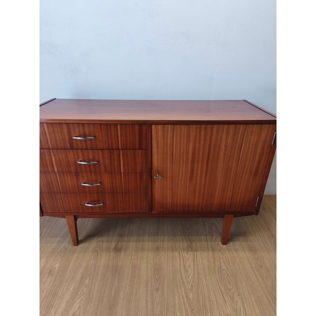 A modernist, long chest of drawers from the 1970s. A simple, minimalist chest of drawers. Original condition, unrestored,...