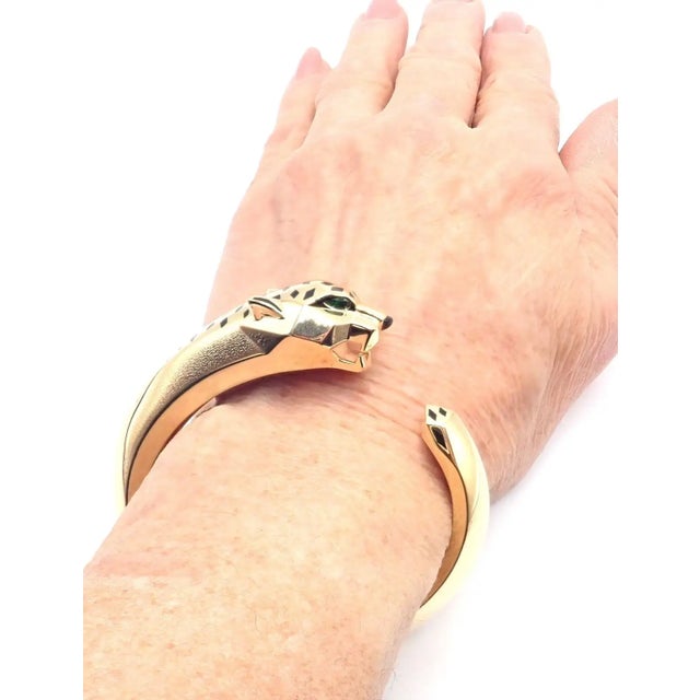 18k Yellow Gold Panther Panthere Tavorite Onyx Size 16 Panther Bangle Bracelet by Cartier. This bracelet comes with...