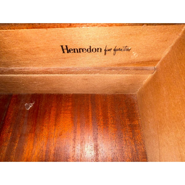 A gorgeous mid-century modern Hollywood Regency Campaign style dresser or credenza Masterfully crafted from rich wood with...