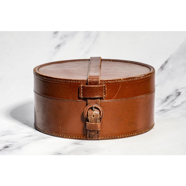 A refined nod to classic gentleman’s dressing, this antique round leather collar box embodies the understated elegance of...