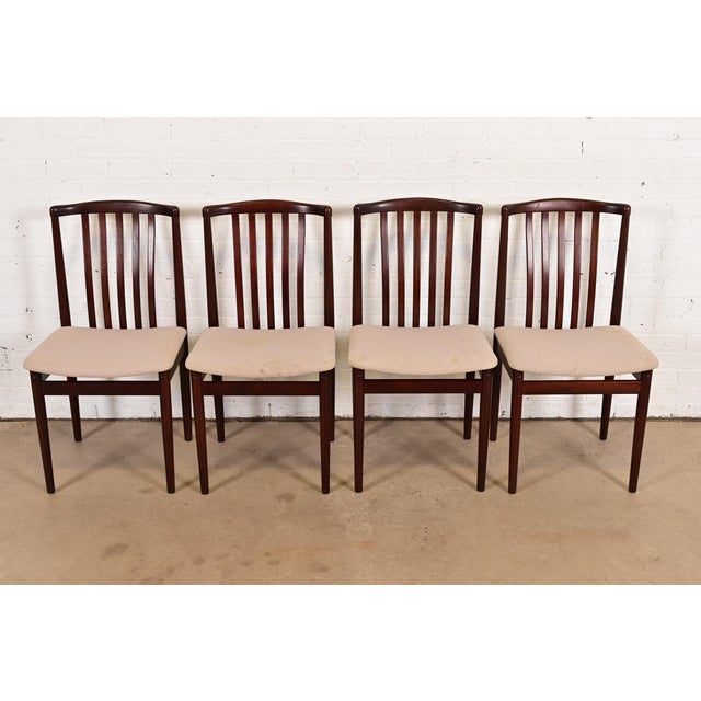 A sleek and stylish set of four mid-century Danish Modern sculpted rosewood dining chairs By Vamdrup Stolefabrik Denmark,...