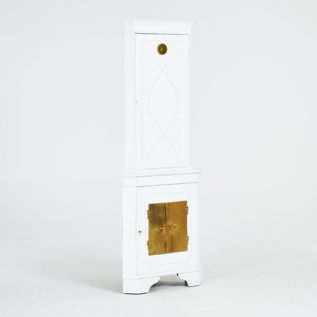 Tiled stove corner cabinet from the 1950s. The color is old white. The brass doors for the tiled stove and the brass...