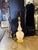 The is cream color double gourd ceramic body in a cream color. The body has about 8” diameter. Base is painted metal in...