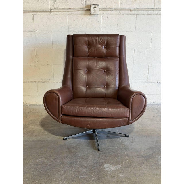 This ergonomic lounge chair features a highback contoured frame with tufted cushioning and padded armrests. Its graceful...