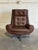 This ergonomic lounge chair features a highback contoured frame with tufted cushioning and padded armrests. Its graceful...
