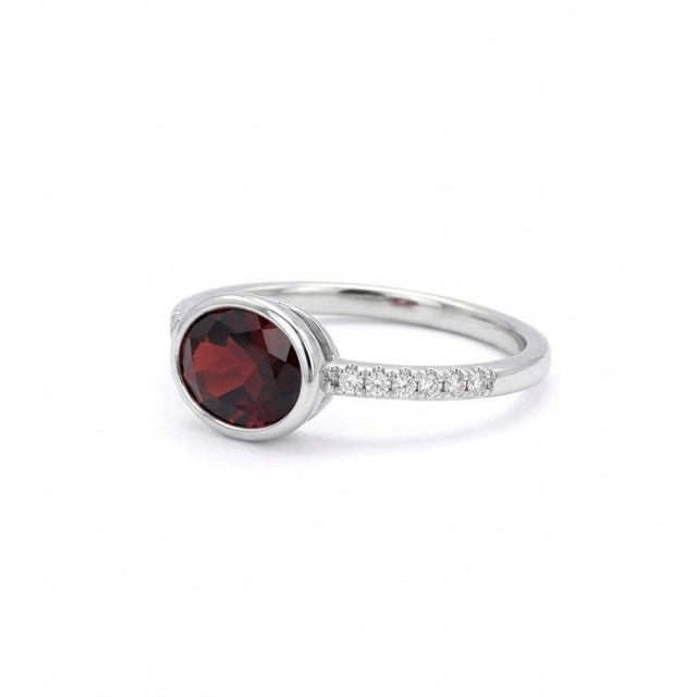 Professional Product Description: This refined ring features a captivating Garnet gemstone, celebrated for its deep red...