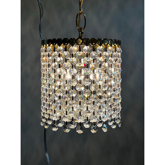 Vintage Mid 20th Century Hollywood Regency crystal waterfall pendant light with chain and canopy. Crystals are high...