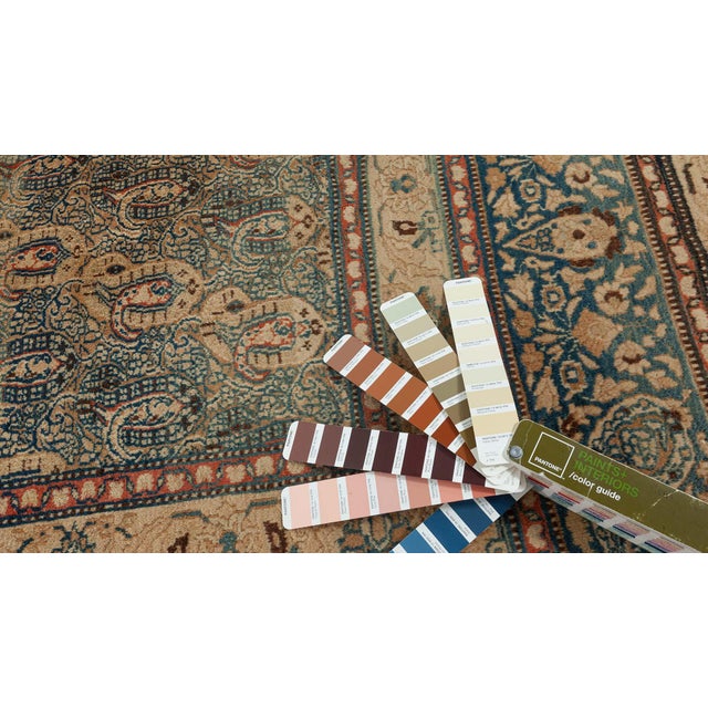 An early 20th century antique Persian Meshad carpet, having a dense field with closely staggered botehs in a palette of...